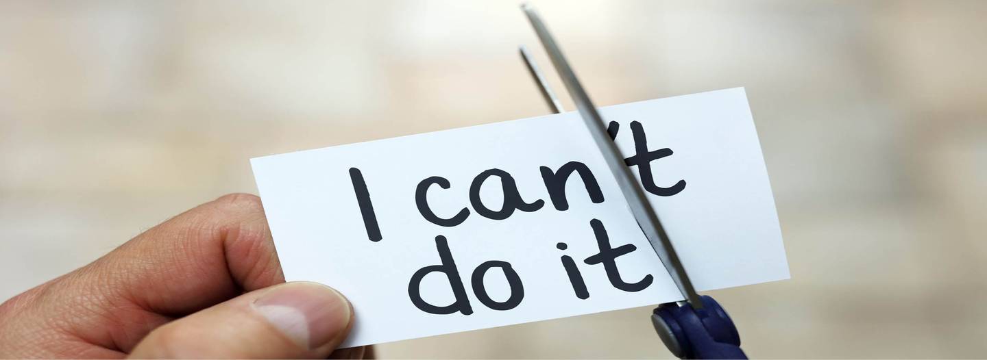 Ein Zettel auf dem 'I can't do it" steht, wird mit einer Schere durchgeschnitten.
